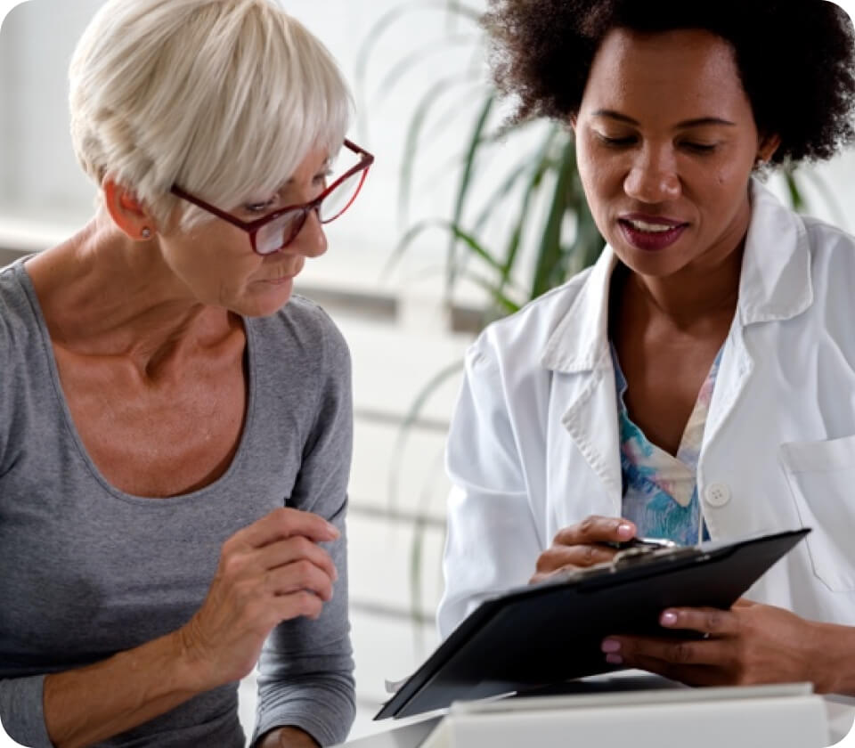 A person and a doctor discussing treatment